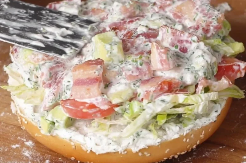 California Chopped BLT Bagel with bacon, lettuce, and tomato on a toasted bagel