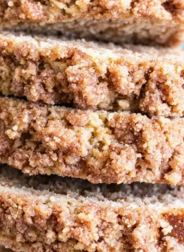 Slice of coffee cake banana bread on a plate with a coffee cup