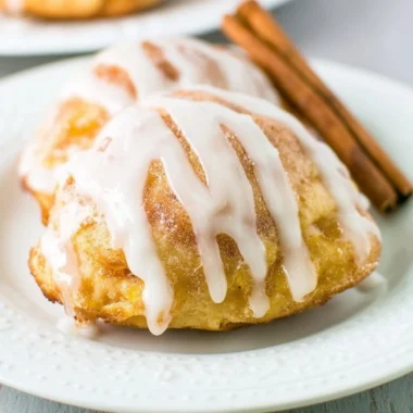 Fresh peach fritters served on a plate, golden and fluffy.
