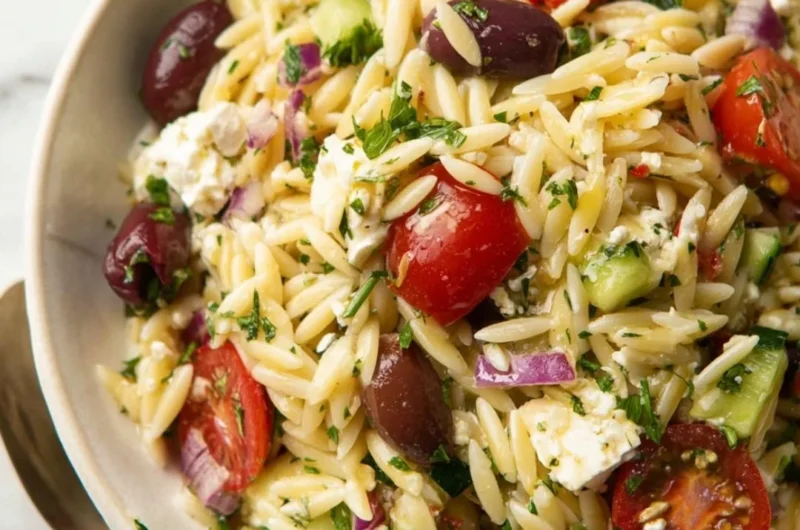 Colorful Greek Orzo Pasta Salad with vegetables and feta cheese