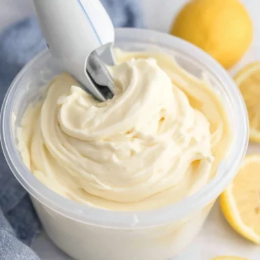 Delicious Ninja Creami lemon gelato in a bowl garnished with lemon slices.