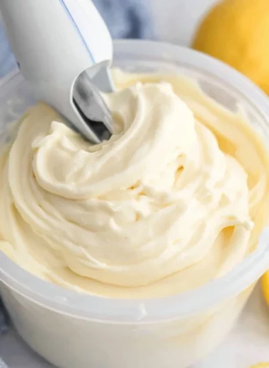 Delicious Ninja Creami lemon gelato in a bowl garnished with lemon slices.