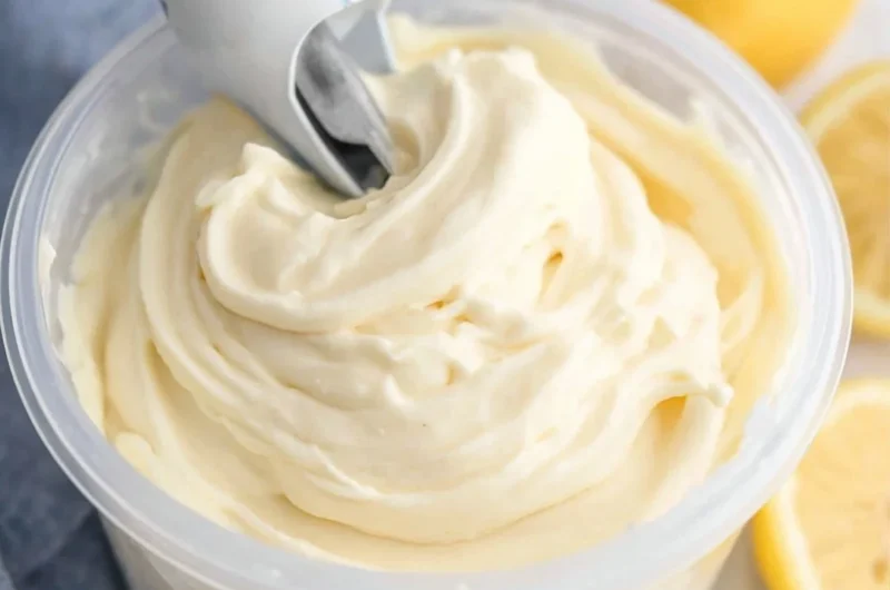 Delicious Ninja Creami lemon gelato in a bowl garnished with lemon slices.
