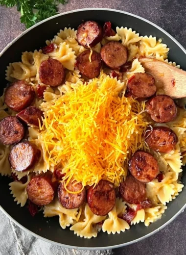 One pot creamy Cajun sausage pasta served in a bowl with fresh herbs