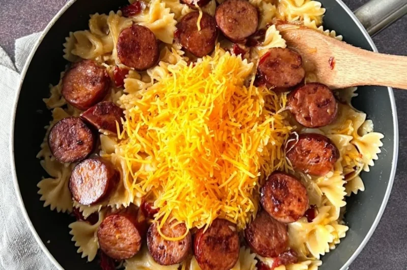 One pot creamy Cajun sausage pasta served in a bowl with fresh herbs