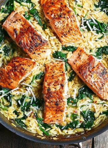 One skillet salmon served with lemon orzo in a bright, colorful dish.