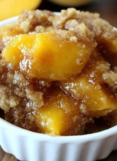 Homemade Peach Crisp dessert with baked peaches and crumble topping