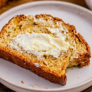 Freshly baked Southern Peach Bread with slices and ripe peaches