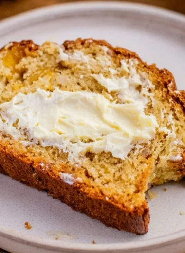 Freshly baked Southern Peach Bread with slices and ripe peaches