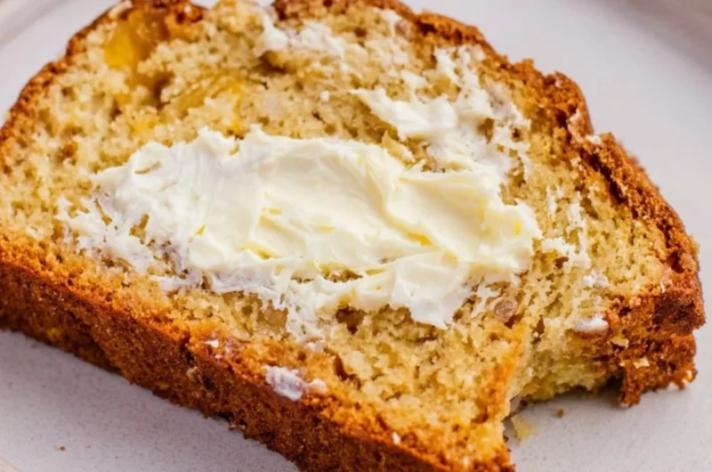 Freshly baked Southern Peach Bread with slices and ripe peaches