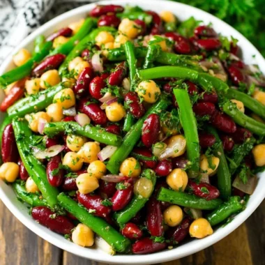 Three bean salad featuring a mix of colorful beans and fresh vegetables