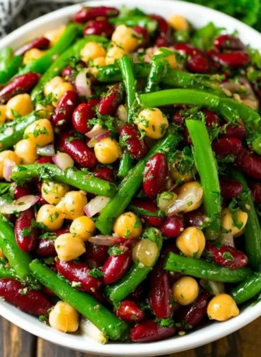 Three bean salad featuring a mix of colorful beans and fresh vegetables