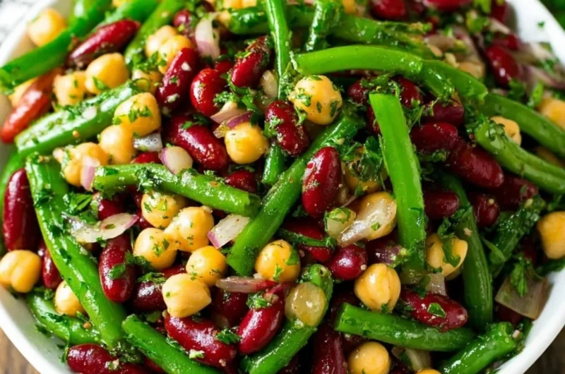 Three bean salad featuring a mix of colorful beans and fresh vegetables