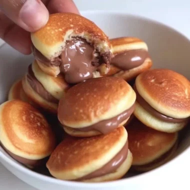 Fluffy stack of best pancakes with syrup and berries on a plate
