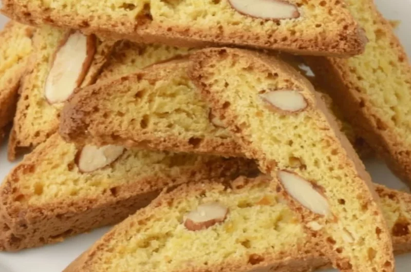 Plate of crispy Cantucci cookies, ideal for dipping in coffee or tea.