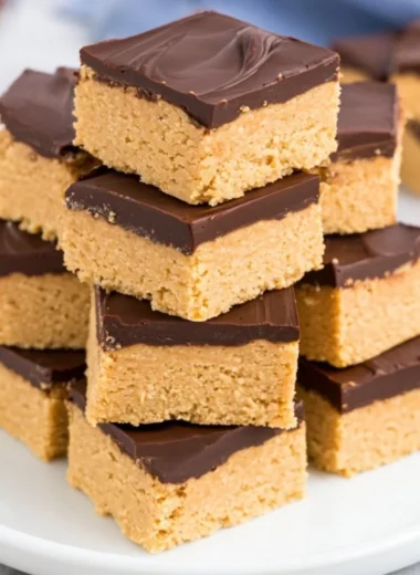 Delicious Chocolate Peanut Butter Squares topped with chocolate drizzle