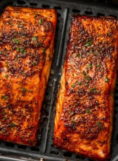 Deliciously cooked easy air fryer salmon on a plate with herbs