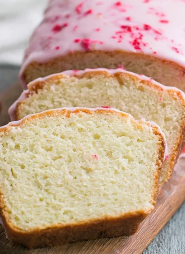 Slice of Key Lime Cake with Raspberry Glaze on a plate