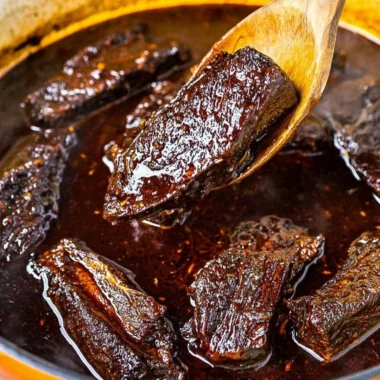 Korean braised short ribs served with garnishes and rice