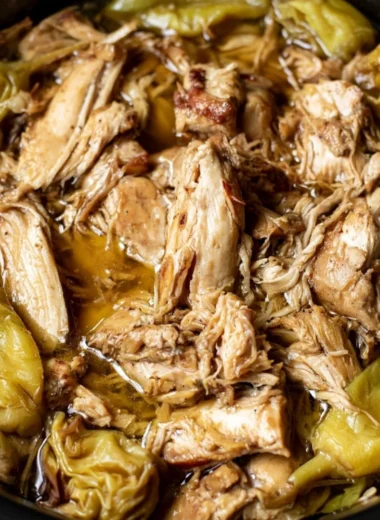 Delicious plate of Mississippi Chicken served with sides and garnished.