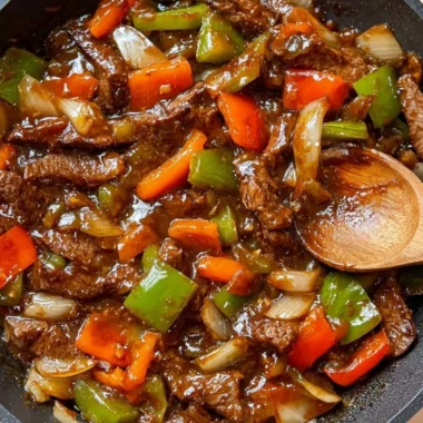 Delicious homemade pepper steak served with colorful pepper slices and savory sauce
