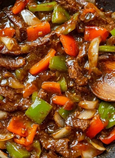 Delicious homemade pepper steak served with colorful pepper slices and savory sauce