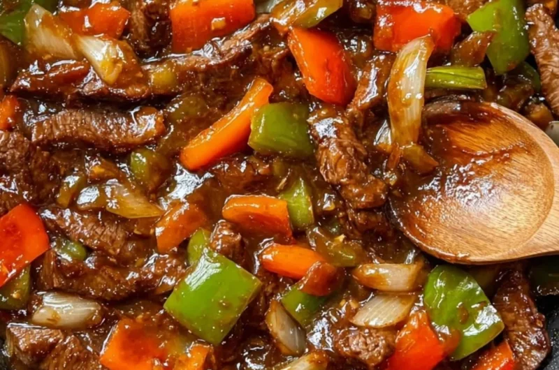 Delicious homemade pepper steak served with colorful pepper slices and savory sauce