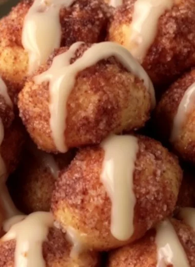 Delicious quick cinnamon roll bites arranged on a plate with icing