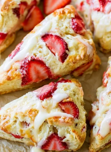 Freshly baked strawberries and cream scones on a decorative plate