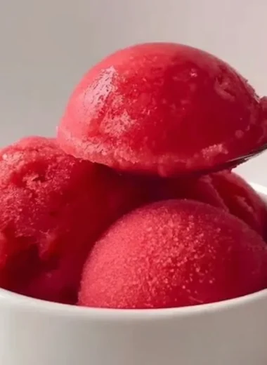 Delicious strawberry sorbet served in a bowl with fresh strawberries