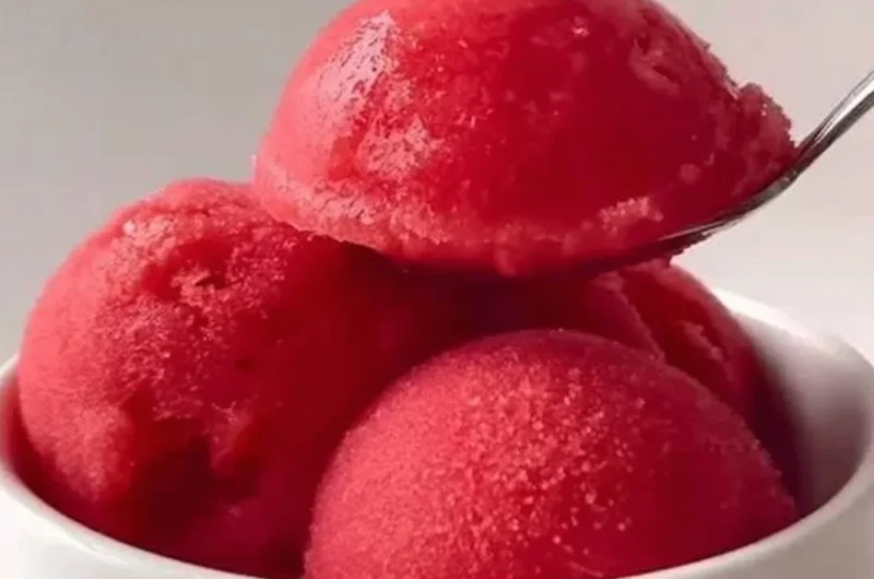 Delicious strawberry sorbet served in a bowl with fresh strawberries