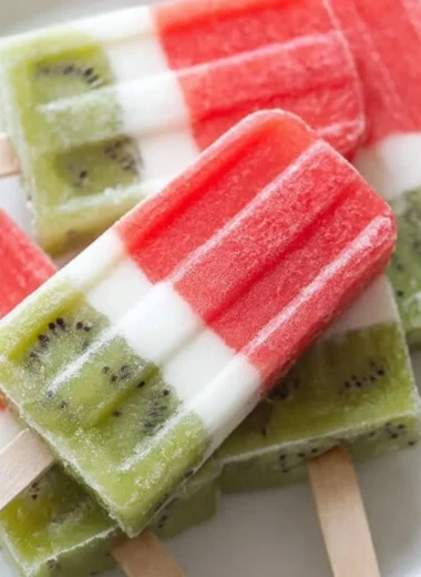 Refreshing watermelon popsicles served on a wooden stick, perfect summer treat
