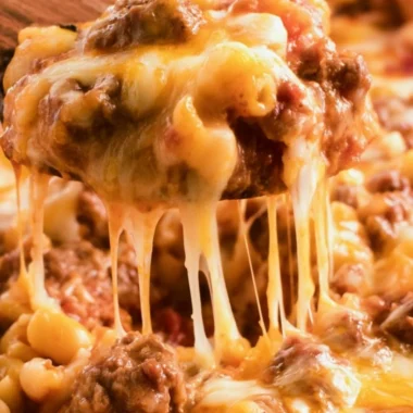 Cheeseburger casserole topped with melted cheese and fresh toppings