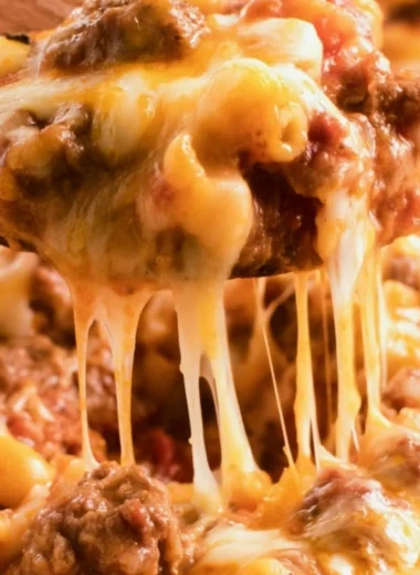 Cheeseburger casserole topped with melted cheese and fresh toppings