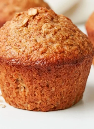 Baked healthy banana oatmeal muffins topped with oats and bananas.