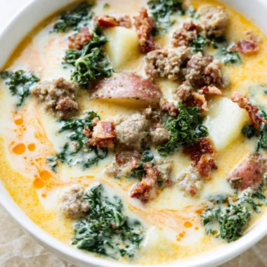 Bowl of Instant Pot Tuscan Soup garnished with fresh herbs and bread croutons