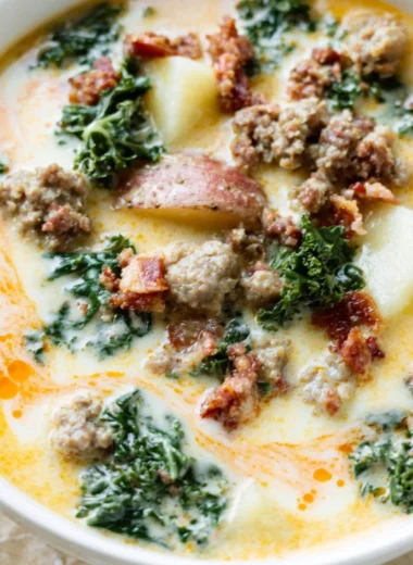 Bowl of Instant Pot Tuscan Soup garnished with fresh herbs and bread croutons