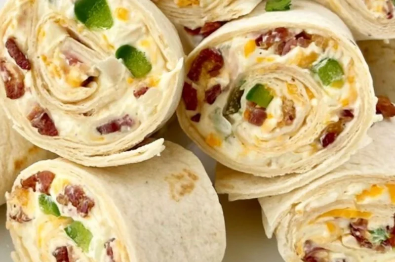 Delicious jalapeno poppers pinwheels appetizer on a platter.