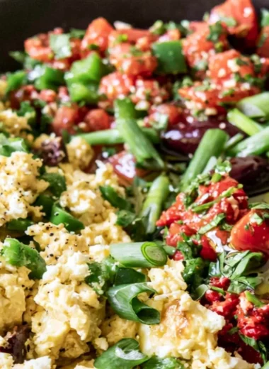 Colorful Mediterranean breakfast bowl with fresh vegetables and grains