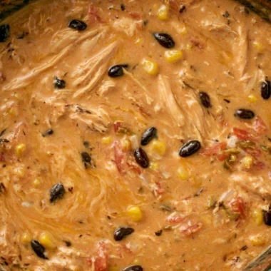 Bowl of slow cooker creamy chicken tortilla soup garnished with tortilla strips