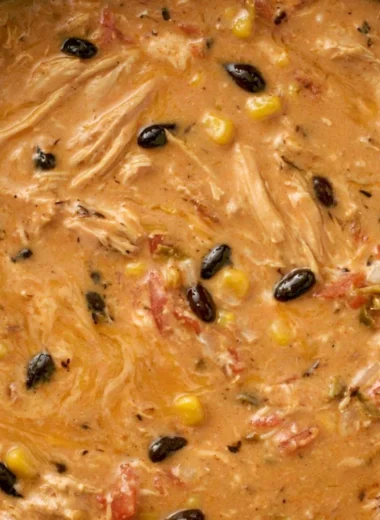 Bowl of slow cooker creamy chicken tortilla soup garnished with tortilla strips