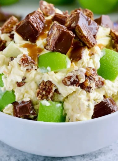 Delicious Snickers Apple Salad with apples, Snickers bars, and creamy dressing