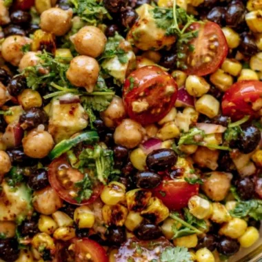 Bowl of Southwest Chickpea Black Bean Salad with colorful veggies and beans