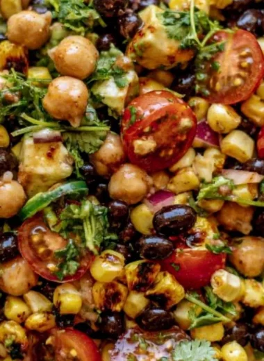 Bowl of Southwest Chickpea Black Bean Salad with colorful veggies and beans