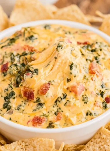 Delicious spinach dip served with chips and vegetables at a party