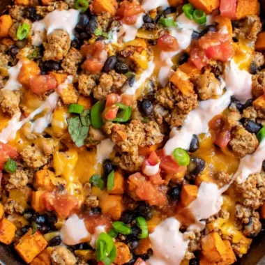 Healthy ground turkey sweet potato tacos skillet topped with fresh ingredients