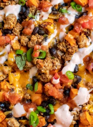 Healthy ground turkey sweet potato tacos skillet topped with fresh ingredients