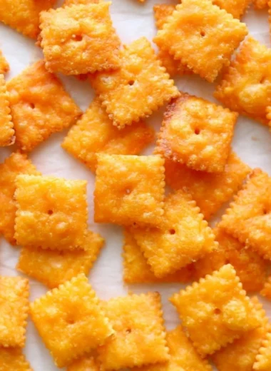 Bowl of crunchy homemade cheese crackers on a rustic wooden table