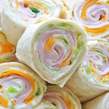 Turkey cheddar lunch roll ups ready to be served on a plate