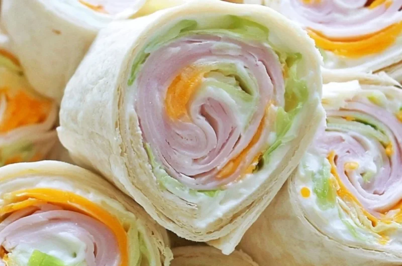 Turkey cheddar lunch roll ups ready to be served on a plate